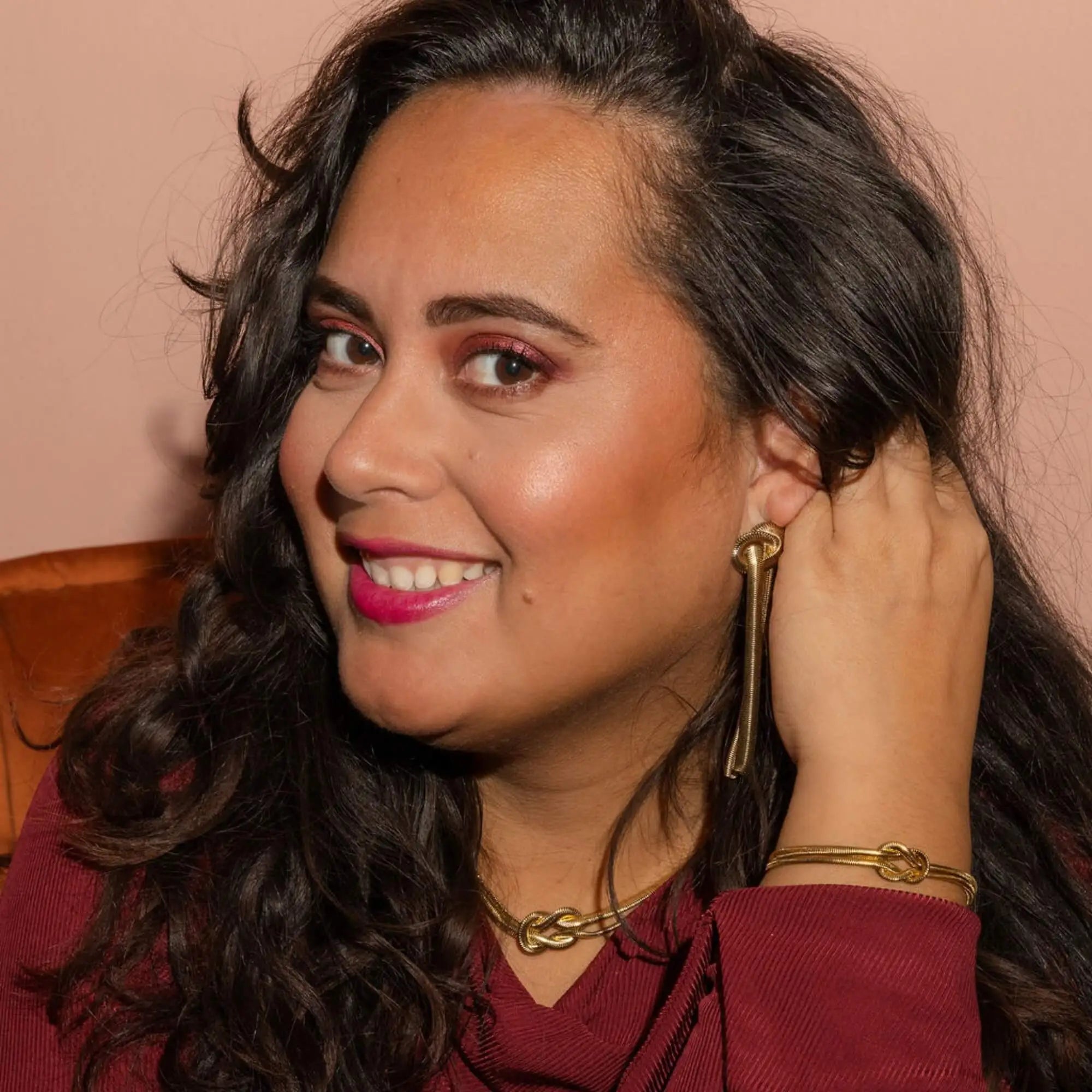 Model draagt de Bound By Beauty Sieradenset in goud – elegante gouden sieraden set voor dames, met betekenisvolle knoop als symbool van kracht.