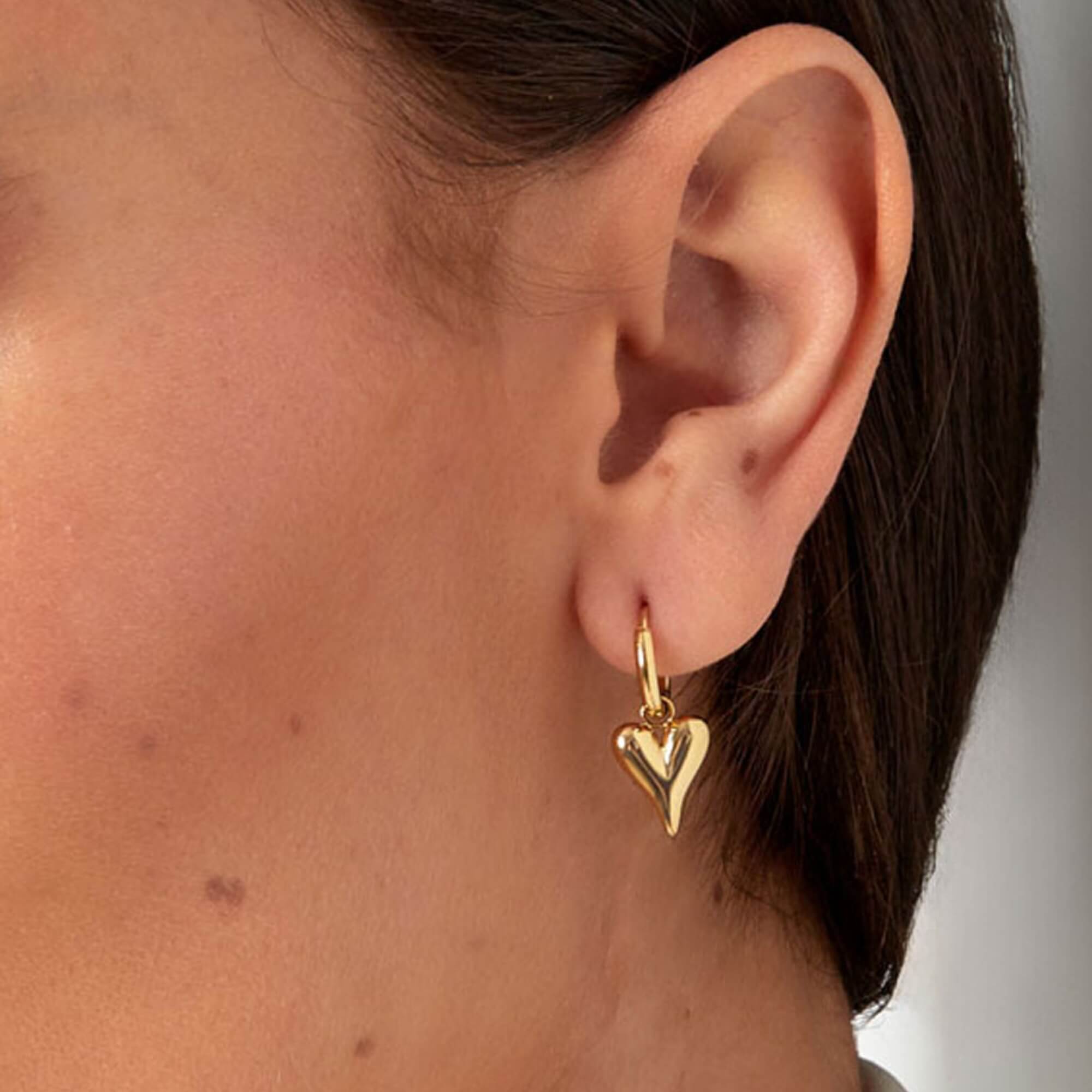 Close up van een model dat de Hoop You Love Me Oorbellen draagt. Dit zijn subtiele hartjes oorbellen.
